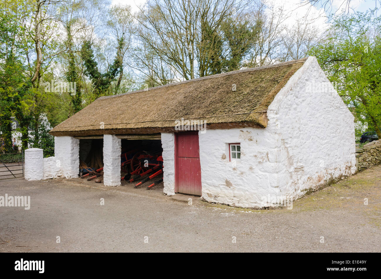 A traditional Irish rural farm building with thatched roof and Stock