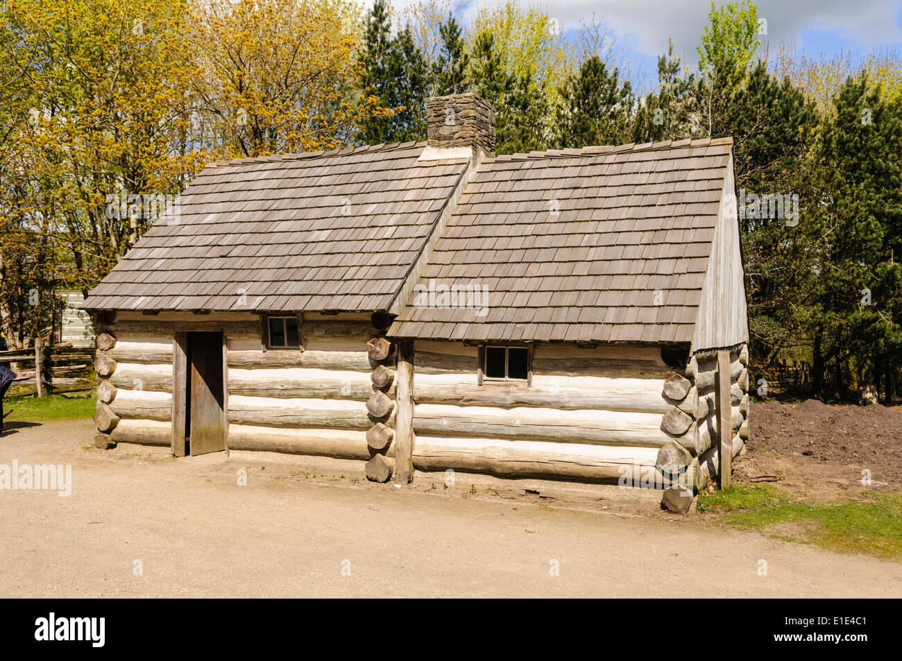 American Log Cabin With Wooden Shingles On The Roof In The Ulster