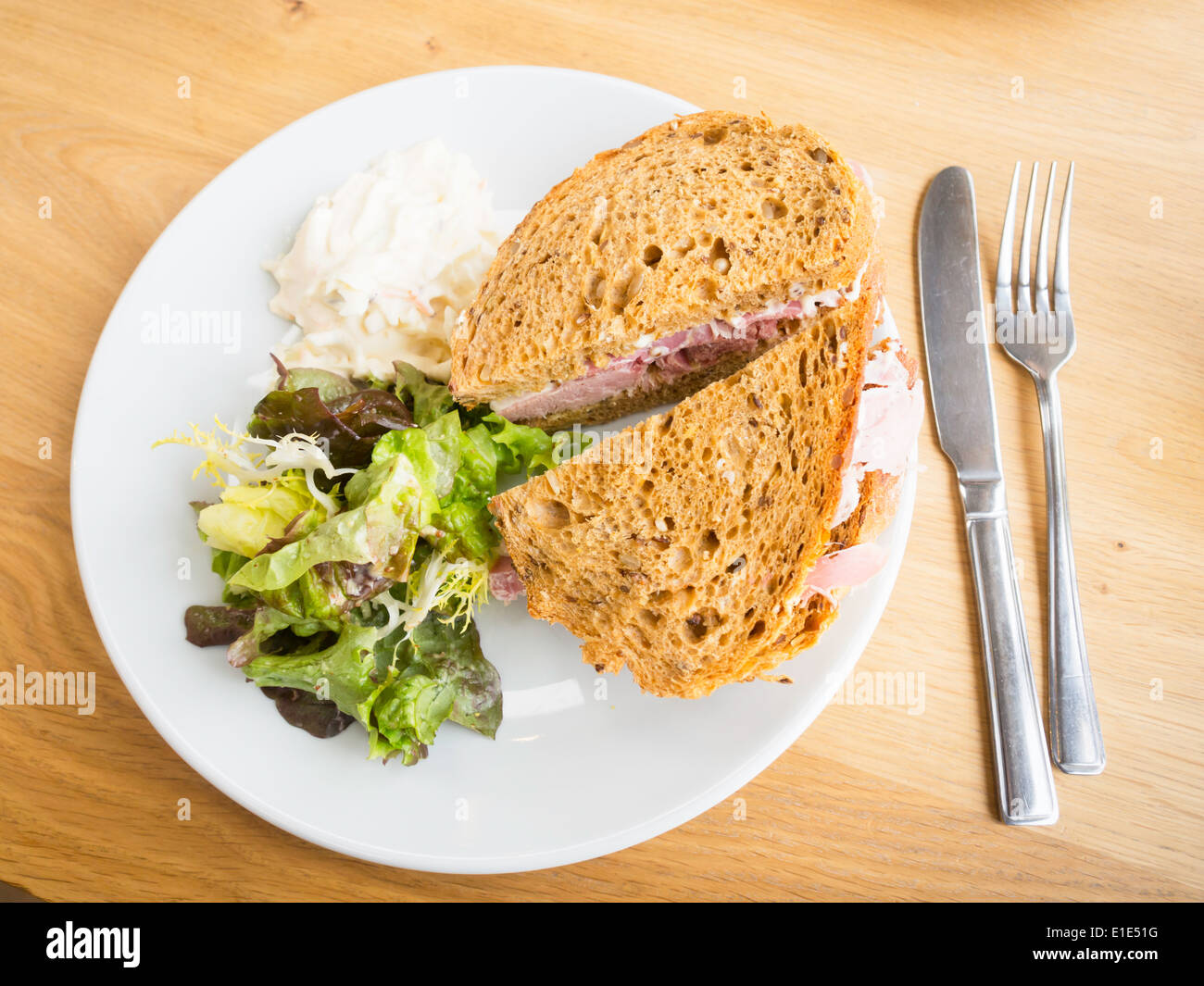 Café lunch a ham sandwich in brown bread with salad coleslaw and mild