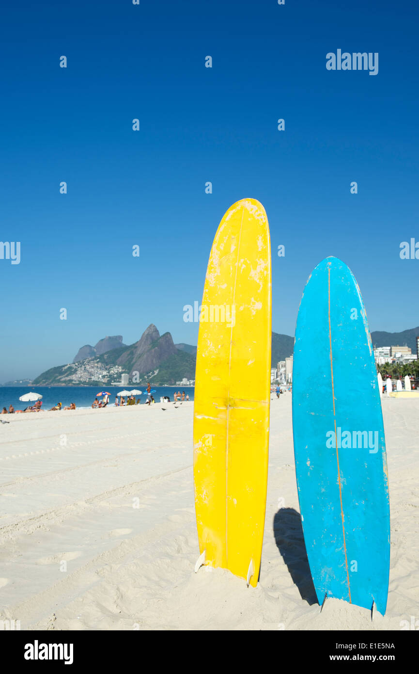 Colorful stand up paddle surfboards standing on the beach at Ipanema, Rio de Janeiro Brazil Stock Photo
