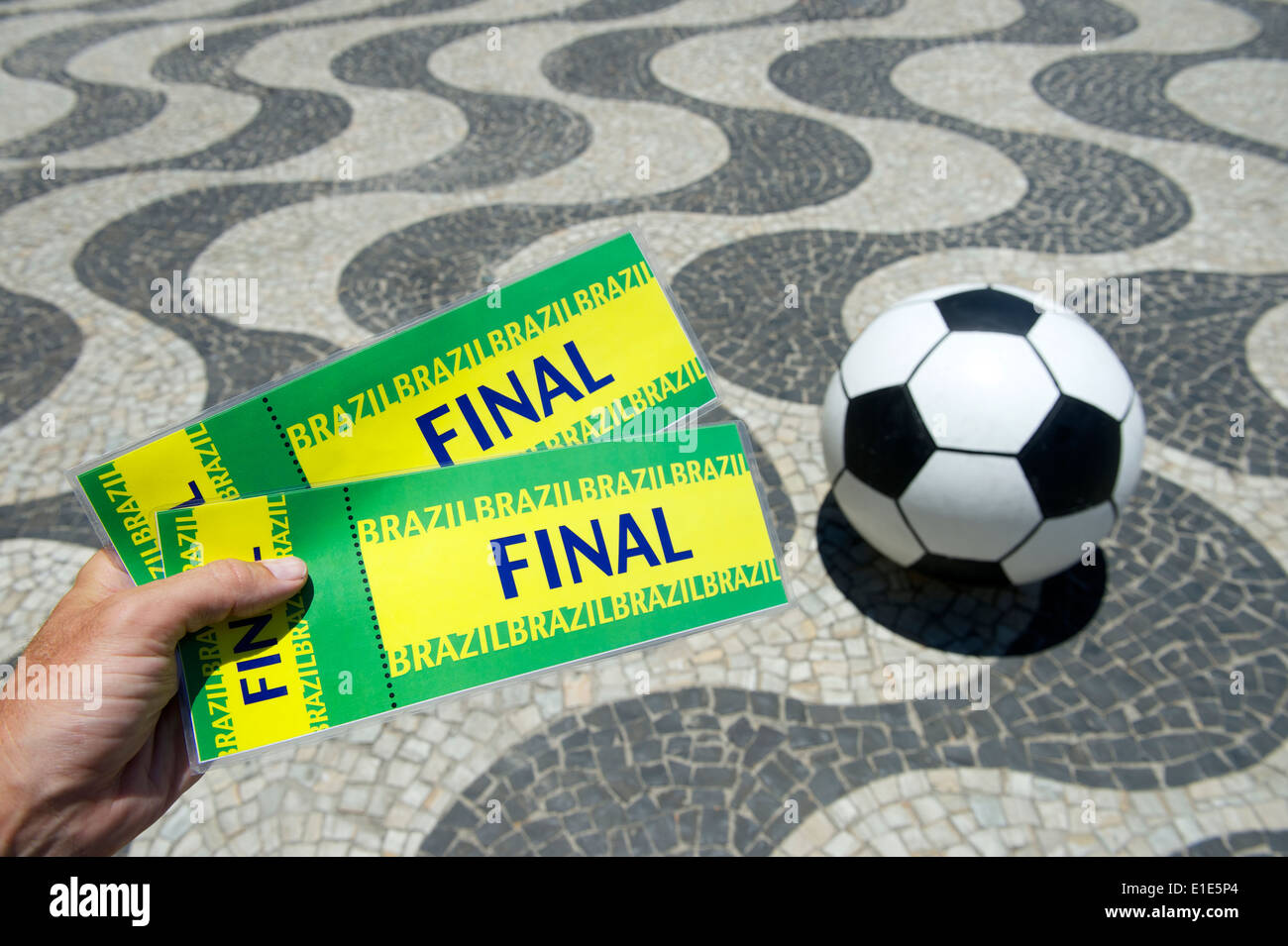 Hand holding pair of tickets to final event in Copacabana Rio de Janeiro Brazil Stock Photo