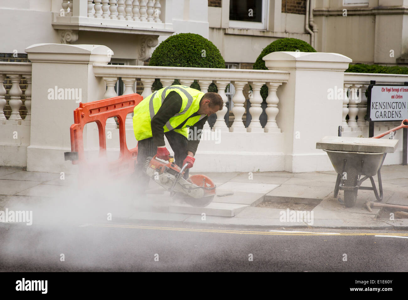 Construction worker cutting cement Stock Photo