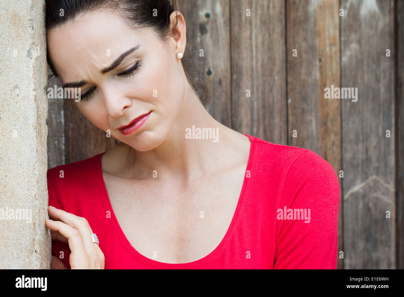 A Depressed Upset And Lonely Woman Leaning Against A Wall Stock Photo Alamy