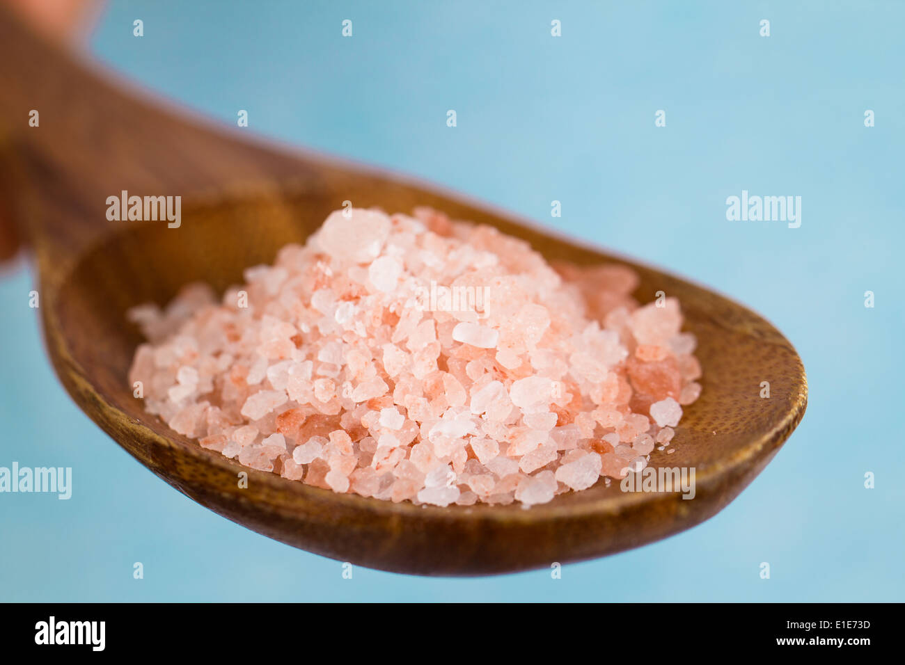 Close-up of pink Himalayan rock-salt on a wooden spoon Stock Photo