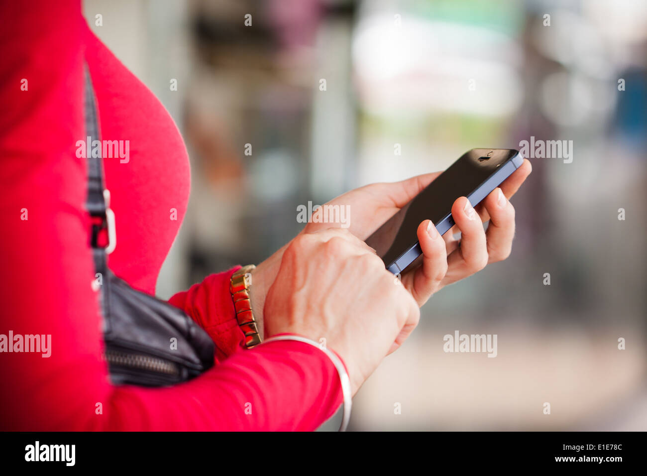 A close-up shot of a woman texting, or using a smartphone cell phone. Stock Photo
