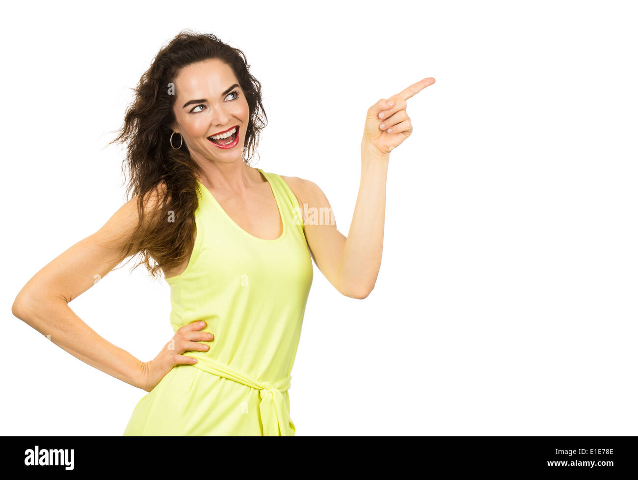 A beautiful positive happy woman pointing and looking at copy-space. Isolated on white. Stock Photo