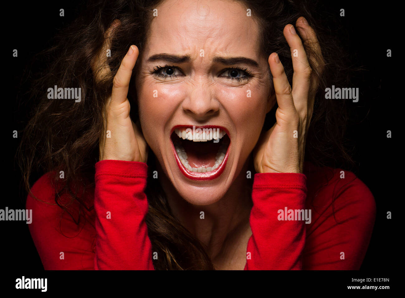 Close-up of a very angry, upset and desperate woman screaming Stock Photo