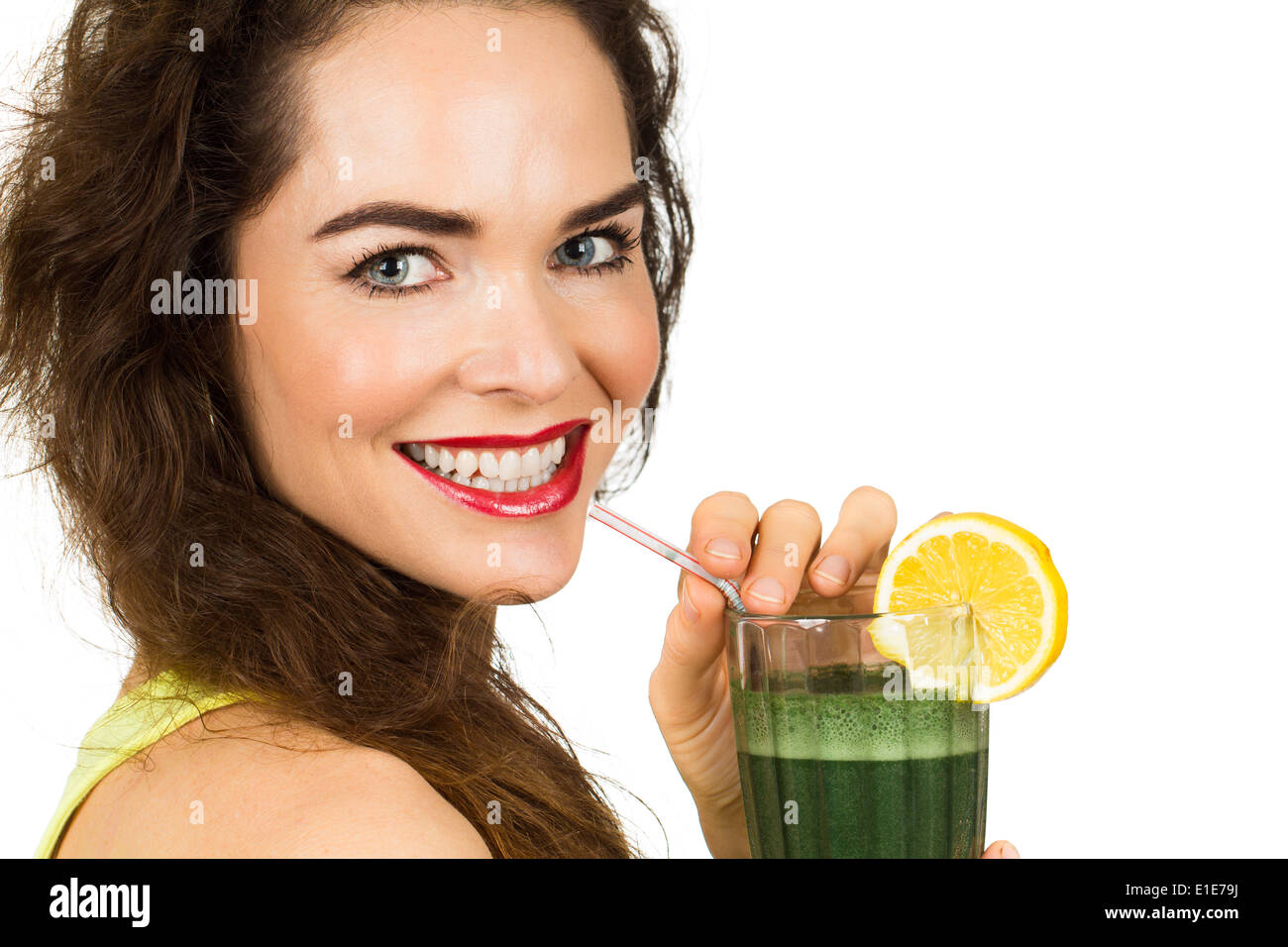 Close-up portrait of a beautiful healthy woman drinking an organic green smoothie. Isolated on white. Stock Photo