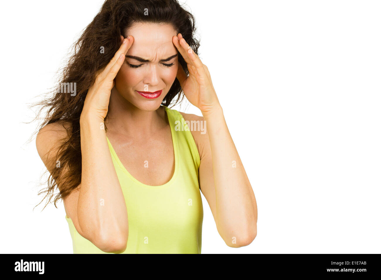 A woman suffering from a bad headache or migraine. Isolated on white. Stock Photo