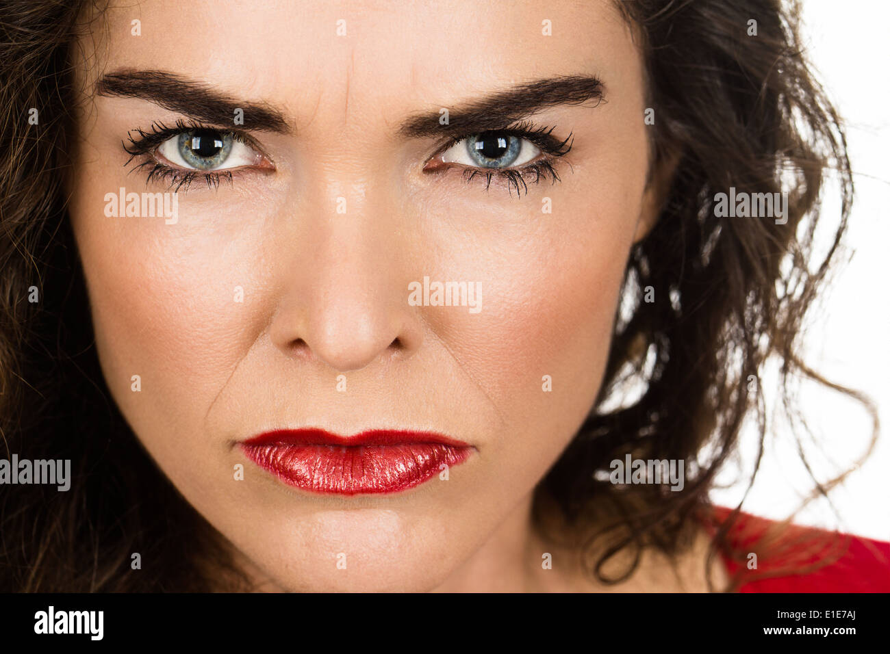 Close-up of a very annoyed and angry woman looking at camera. Stock Photo