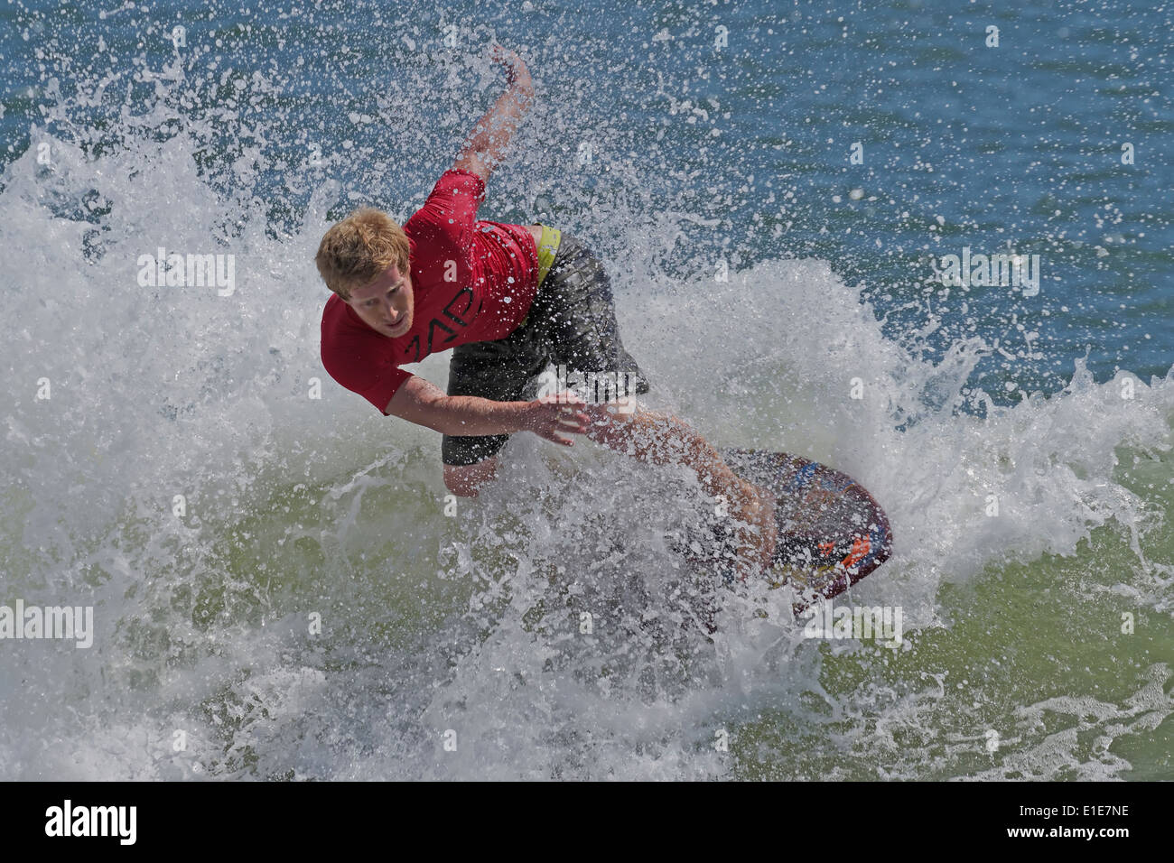 Skimboard Competitor Rides a Wave Stock Photo
