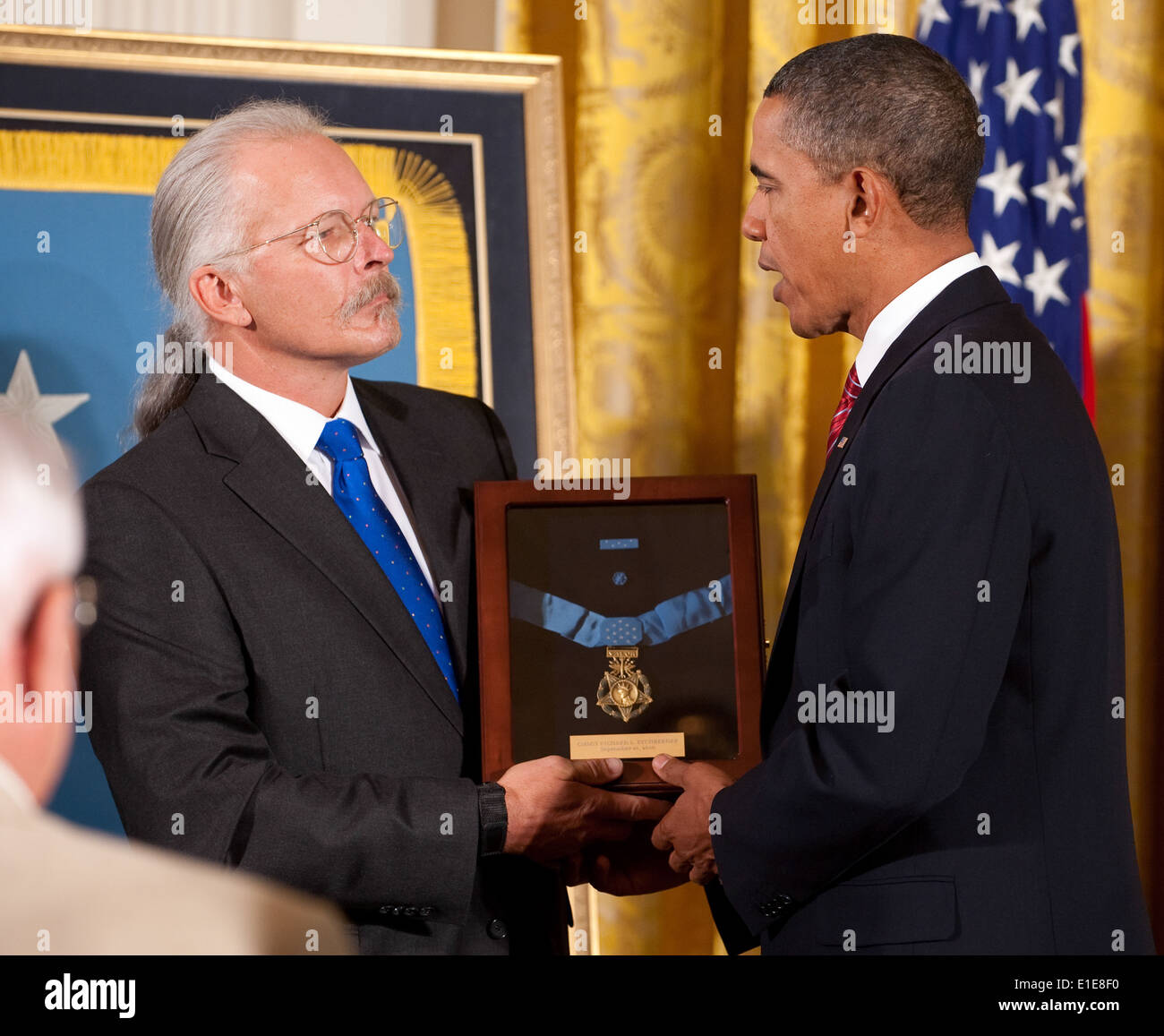 President Barack Obama, right, presents a Medal of Honor award to Richard Etchberger, son of U.S. Air Force Chief Master Sgt. R Stock Photo