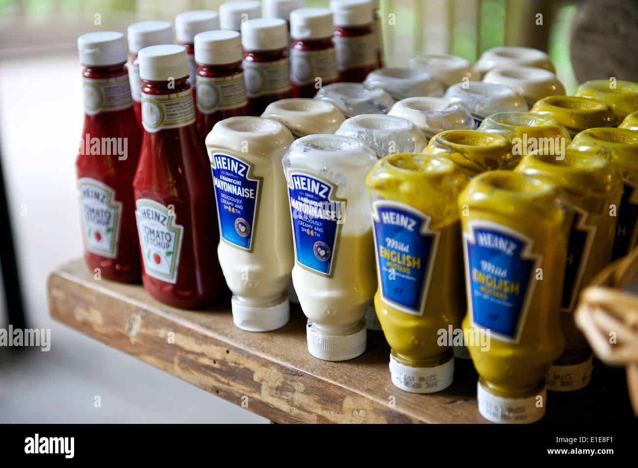 Group of sauces on a table in a restaurant multiple bottles of Stock