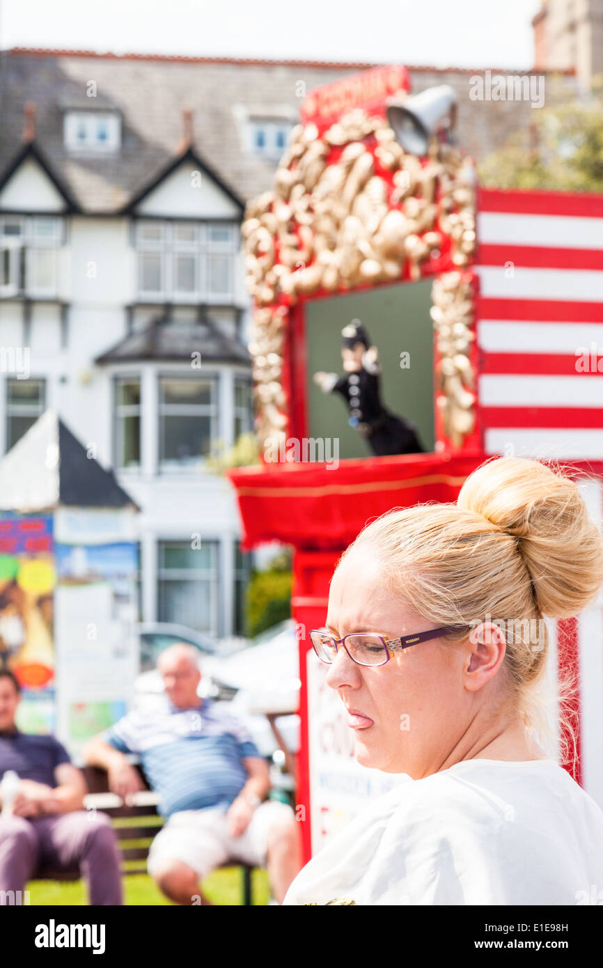 Woman with her eyes closed and tongue out at Punch and Judy show. Llandudno North Wales Great Britain. Stock Photo