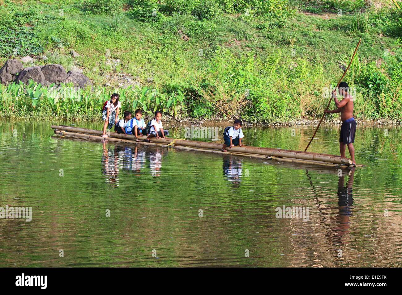 Rizal Province, Philippines. 2nd June, 2014. Students ride a bamboo raft on their way to a remote elementary school in Rizal Province, the Philippines, June 2, 2014. More than 23 million students returned to school on Monday for the first day of classes for the school year of 2014-2015. © Rouelle Umali/Xinhua/Alamy Live News Stock Photo