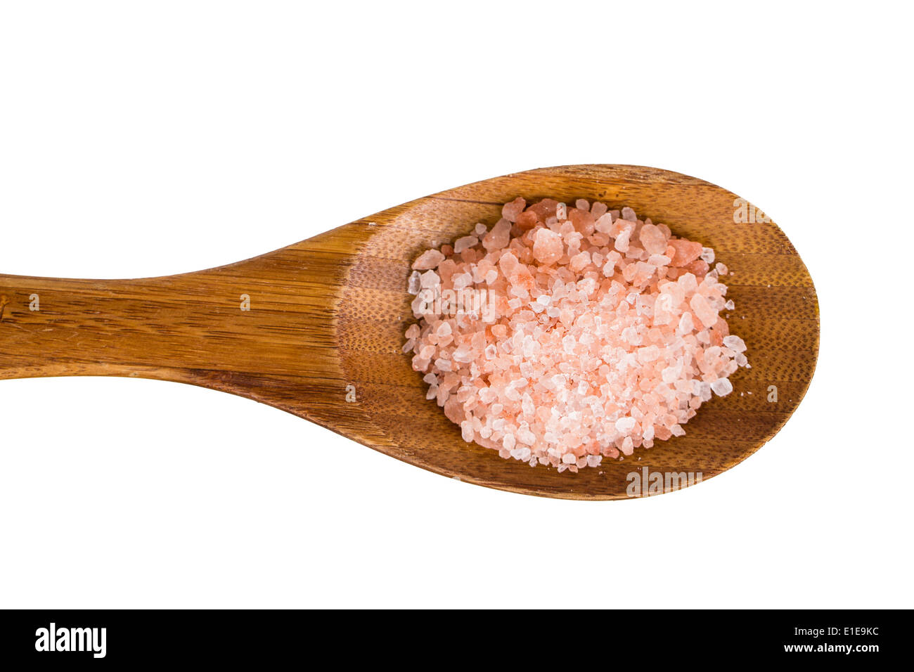 Close-up of pink Himalayan rock-salt on a wooden spoon. Isolated on white. Stock Photo