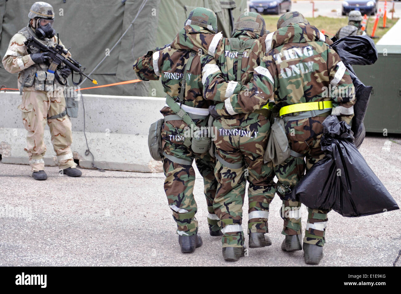 U.S. Airmen participating in a phase two operational readiness exercise help move an Airman with a simulated injury on Ellswort Stock Photo