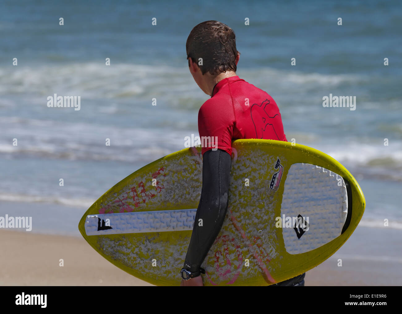 Skimboarder Wearing Wetsuit Searching For A Wave Stock Photo