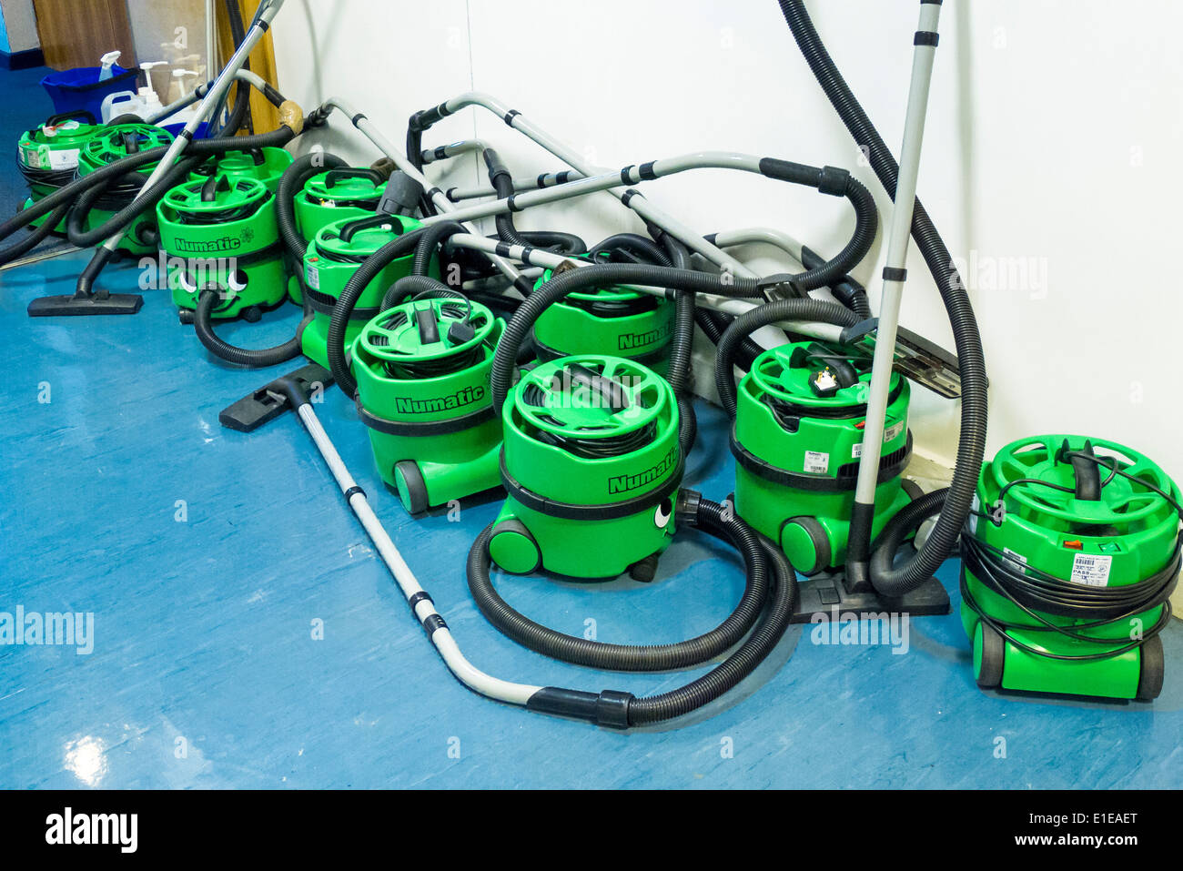 group of Henry Numatic vacuum cleaners in office corridor Stock Photo