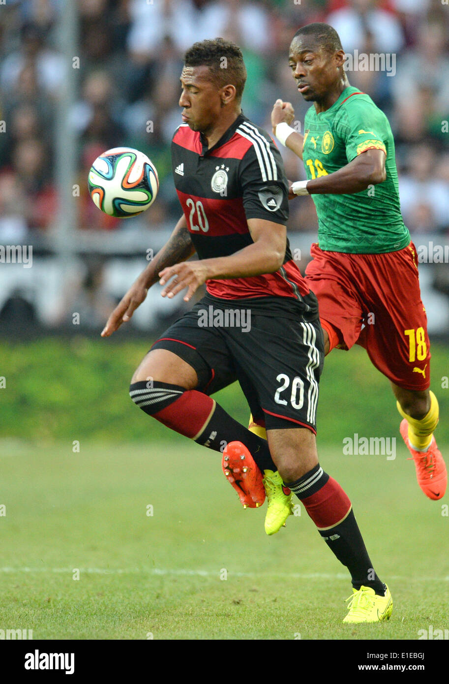 Moenchengladbach, Germany. 01st June, 2014. Germany's Jerome Boateng (L) in action in front of Cameroon's Enoh Eyong during the friendly soccer match between Germany and Cameroon at the Borussia Park stadium in Moenchengladbach, Germany, 01 June 2014. Photo: Bernd Thissen/dpa/Alamy Live News Stock Photo