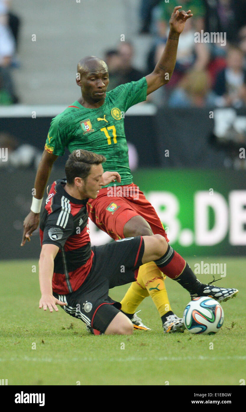 Moenchengladbach, Germany. 01st June, 2014. Germany's Mesut Oezil (L) in action against Cameroon's Stephane Mbia during the friendly soccer match between Germany and Cameroon at the Borussia Park stadium in Moenchengladbach, Germany, 01 June 2014. Photo: Bernd Thissen/dpa/Alamy Live News Stock Photo