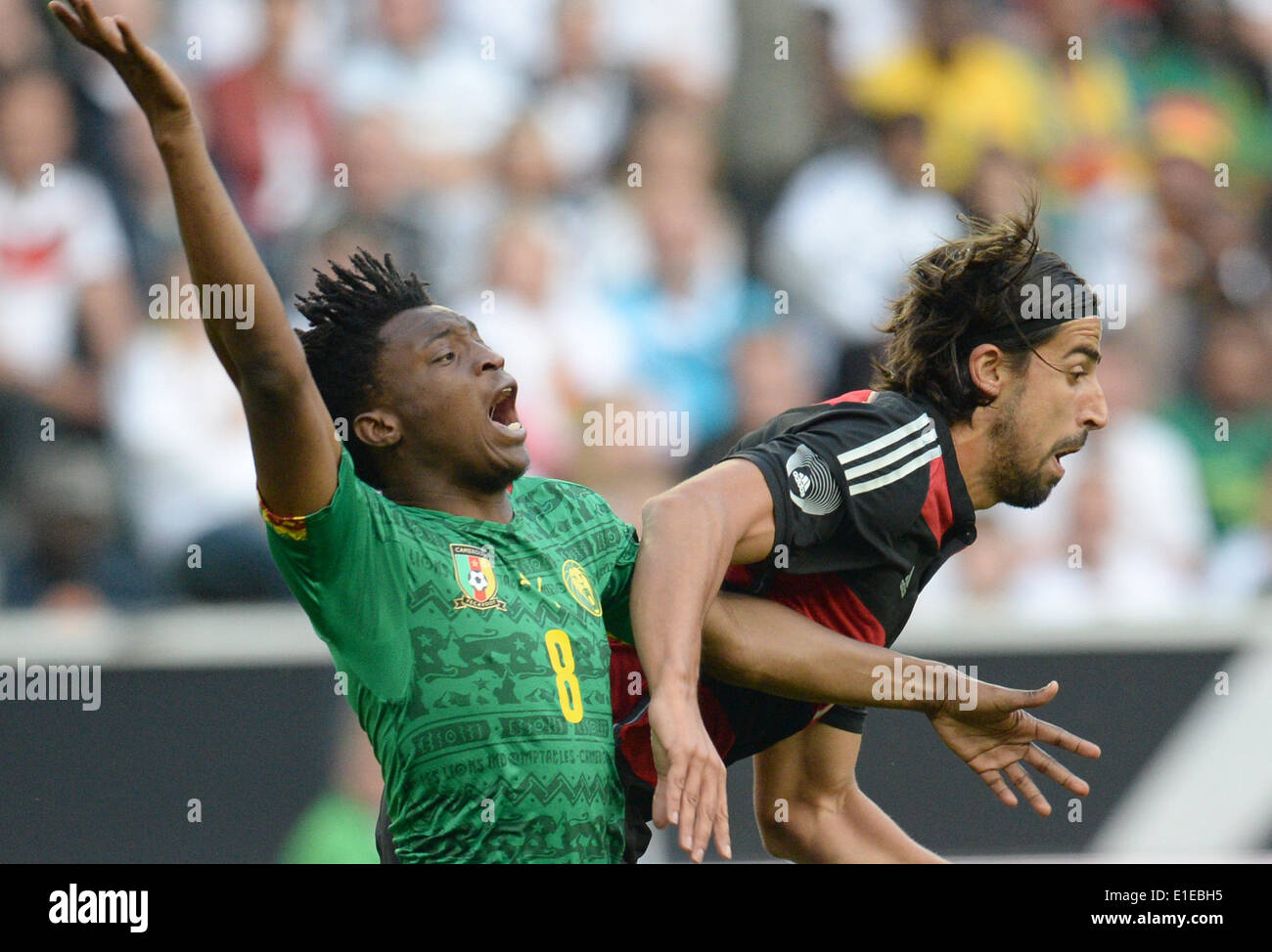Moenchengladbach, Germany. 01st June, 2014. Germany's Sami Khedira (R) in action against Cameroon's Benjamin Moukandjo during the friendly soccer match between Germany and Cameroon at the Borussia Park stadium in Moenchengladbach, Germany, 01 June 2014. Photo: Bernd Thissen/dpa/Alamy Live News Stock Photo