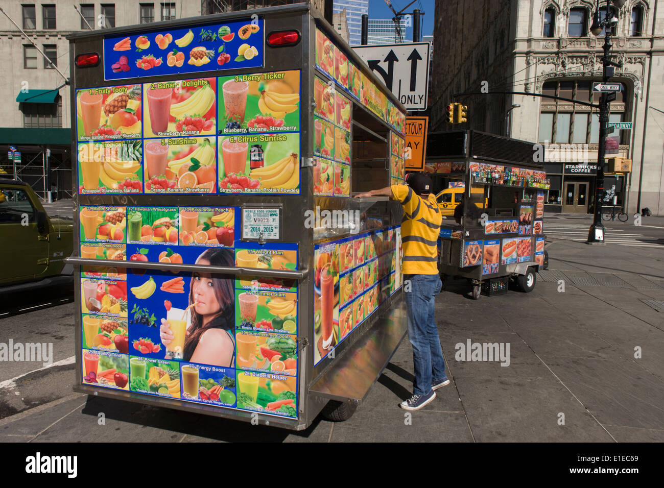 Setting up shop of a kiosk selling multiple varieties of Smoothie fruit