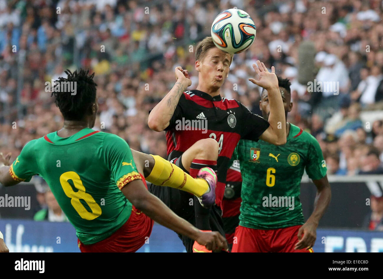 Moenchengladbach, Germany. 01st June, 2014. Germany's Erik Durm (C) in action against Cameroon's Benjamin Moukandjo and Alexandre Song (R) during the friendly soccer match between Germany and Cameroon at the Borussia Park stadium in Moenchengladbach, Germany, 01 June 2014. Photo: Roland Weihrauch/dpa/Alamy Live News Stock Photo
