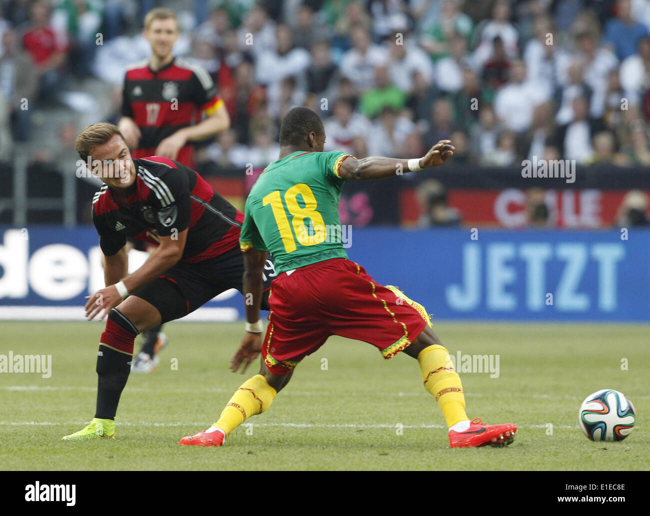 Moenchengladbach, Germany. 01st June, 2014. Germany's Mario Goetze (L) in action against Cameroon's Enoh Eyong during the friendly soccer match between Germany and Cameroon at the Borussia Park stadium in Moenchengladbach, Germany, 01 June 2014. Photo: Roland Weihrauch/dpa/Alamy Live News Stock Photo