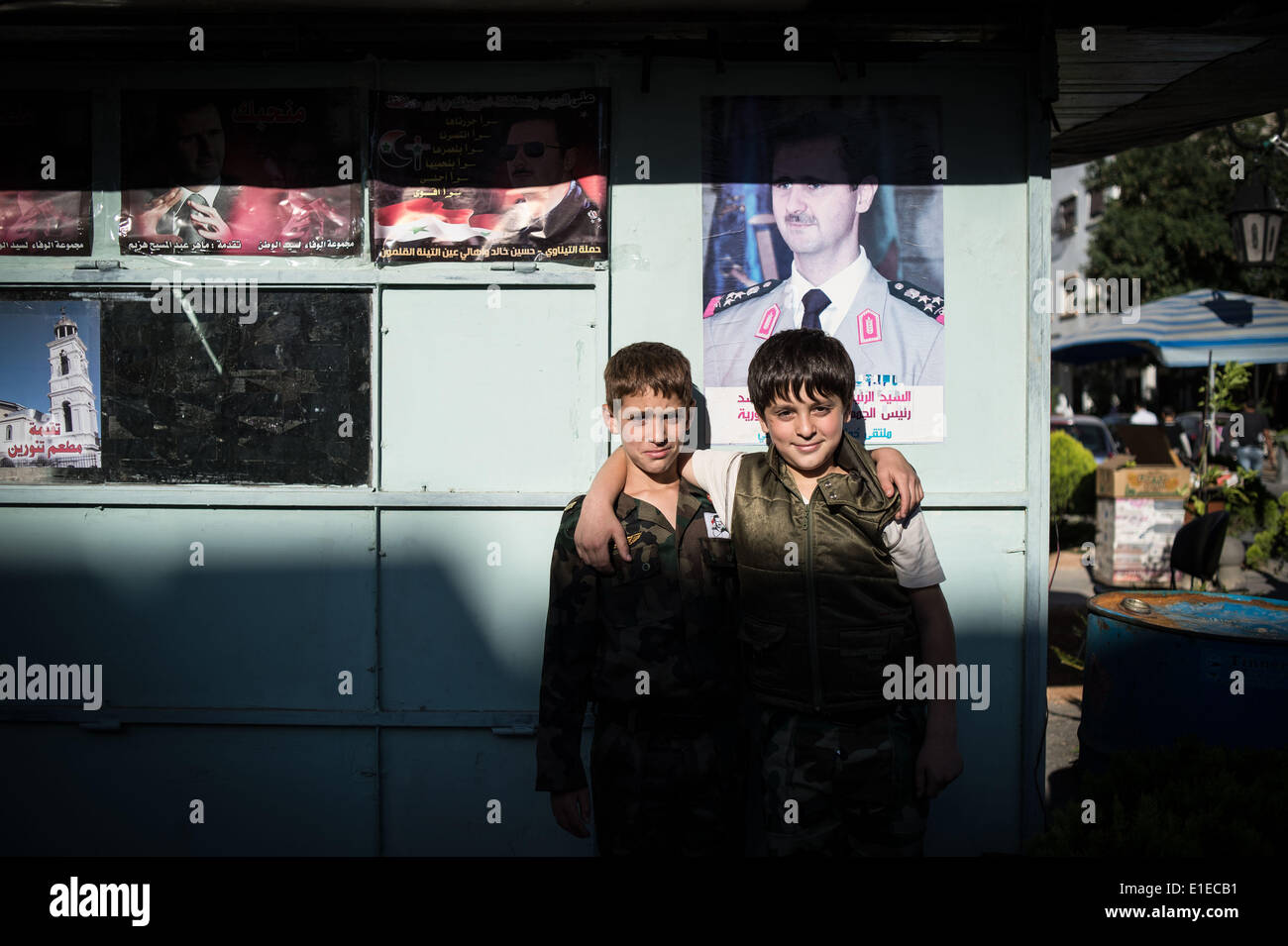 (140602) -- DAMASCUS, June 2, 2014 (Xinhua) --   Syrian boys pose in front of a poster of presidential candidate Bashar al-Assad in Damascus, capital of Syria, on June 1, 2014, ahead of the presidential election on June 3. (Xinhua/Pan Chaoyue) Stock Photo