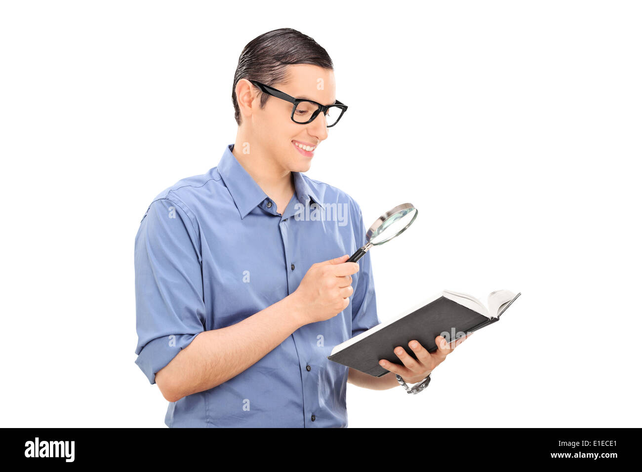 Guy reading a book through a scrutiny Stock Photo