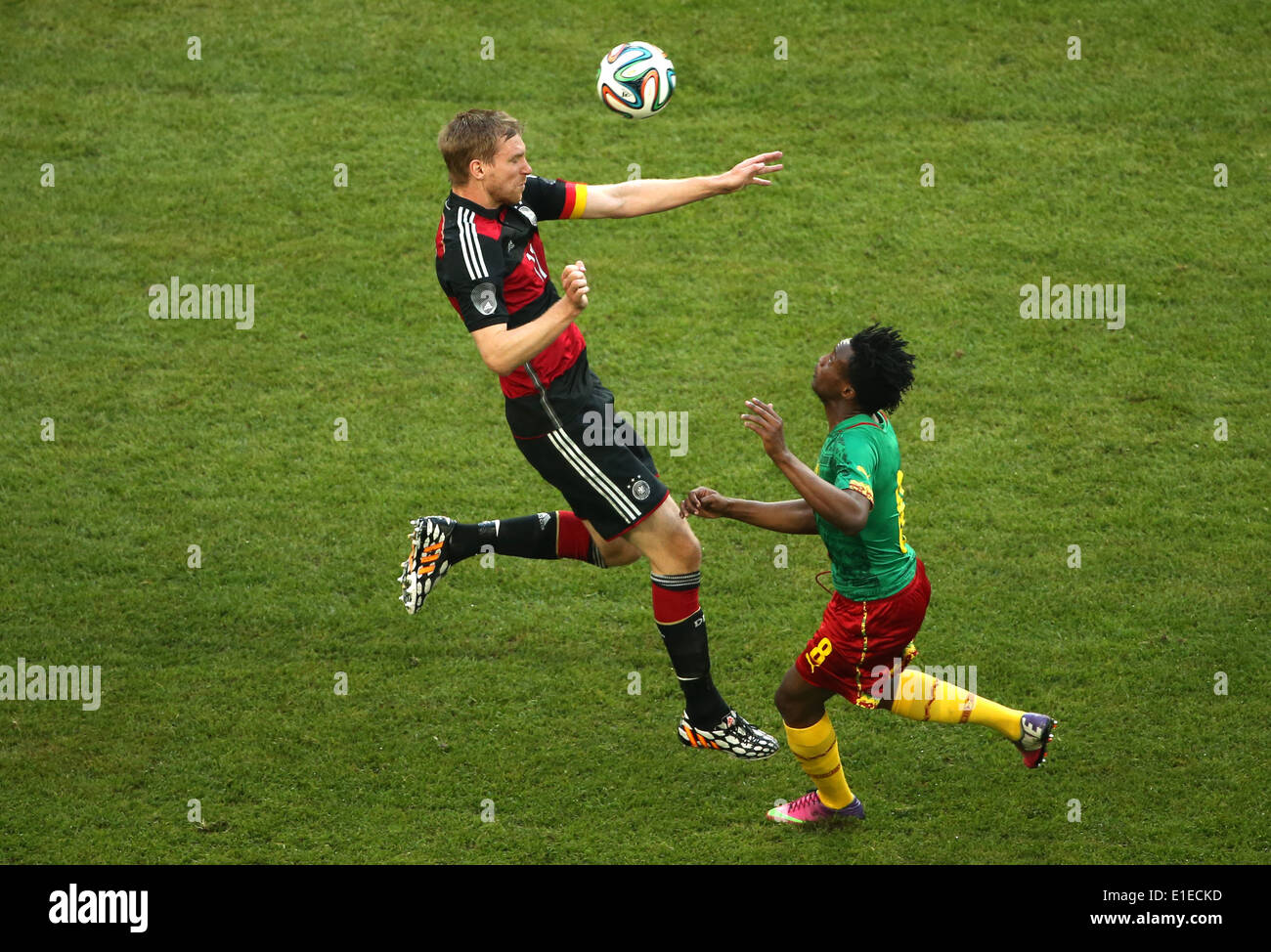 Germany's Per Mertesacker (L) in action against Cameroon's Benjamin Moukandjo during the friendly soccer match between Germany and Cameroon at the Borussia Park stadium in Moenchengladbach, Germany, 01 June 2014. Photo: Rolf Vennenbernd/dpa Stock Photo