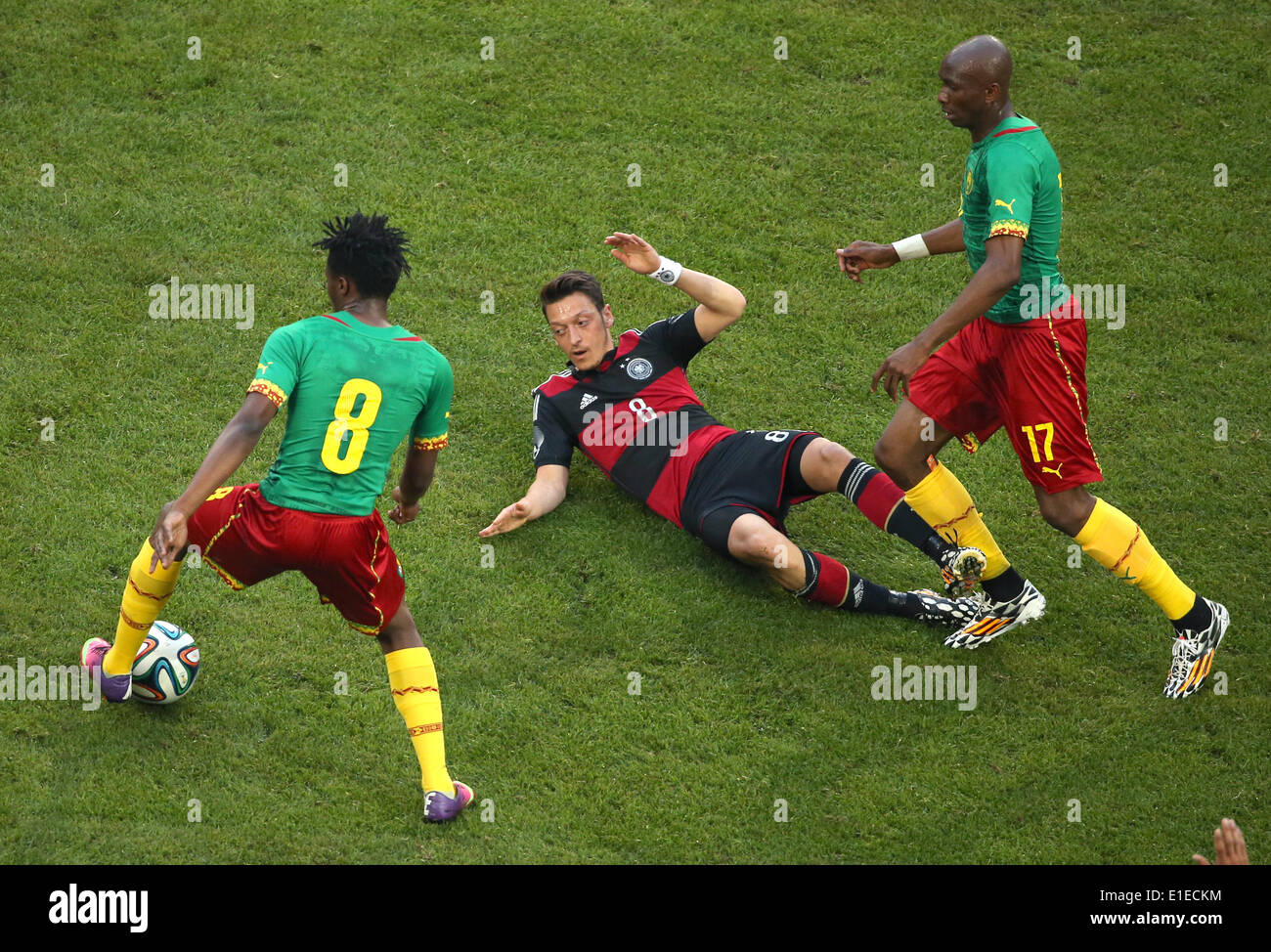 Germany's Mesut Oezil (C) in action against Cameroon's Benjamin Moukandjo (L) and Stephane Mbia  during the friendly soccer match between Germany and Cameroon at the Borussia Park stadium in Moenchengladbach, Germany, 01 June 2014. Photo: Rolf Vennenbernd/dpa Stock Photo