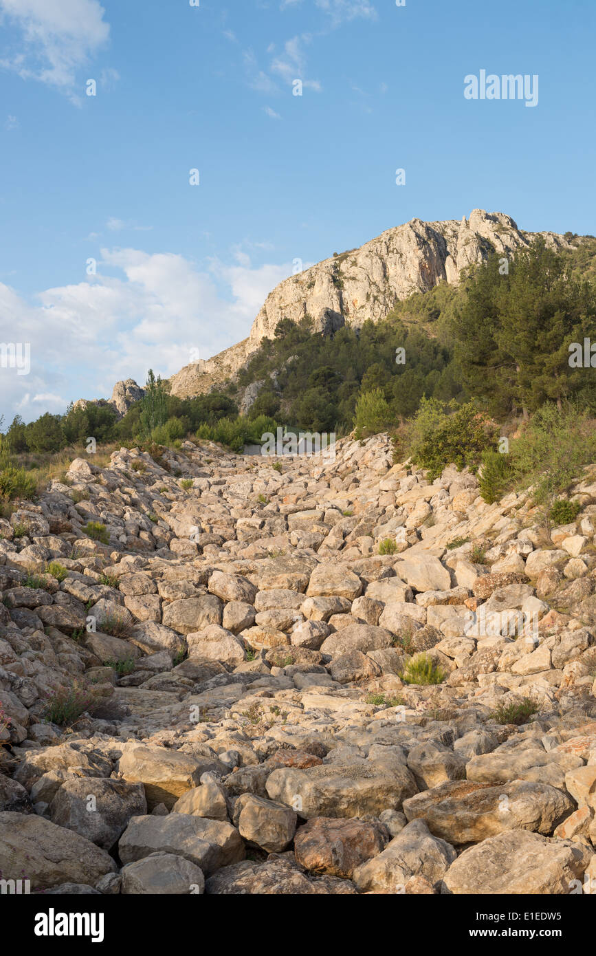 A dry ravine bed full of huge boulders Stock Photo