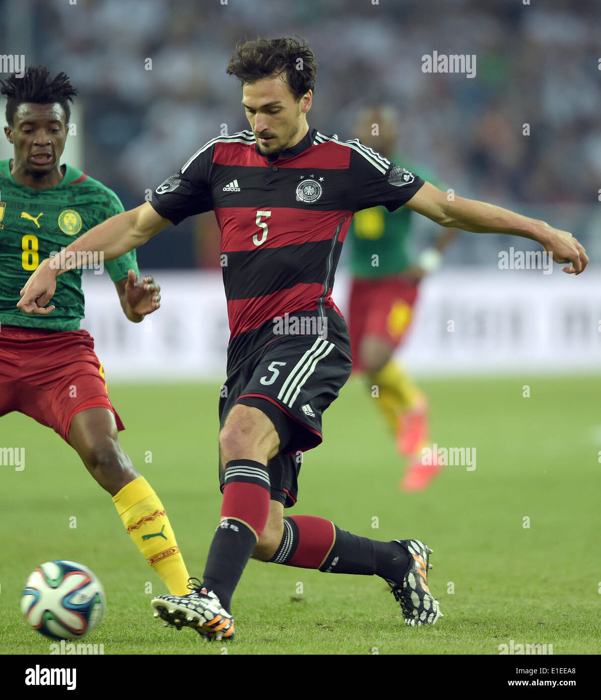 Moenchengladbach, Germany. 01st June, 2014. Germany's Mats Hummels in action against Cameroon's Benjamin Moukandjo during the friendly soccer match between Germany and Cameroon at the Borussia Park stadium in Moenchengladbach, Germany, 01 June 2014. Photo: Federico Gambarini/dpa/Alamy Live News Stock Photo