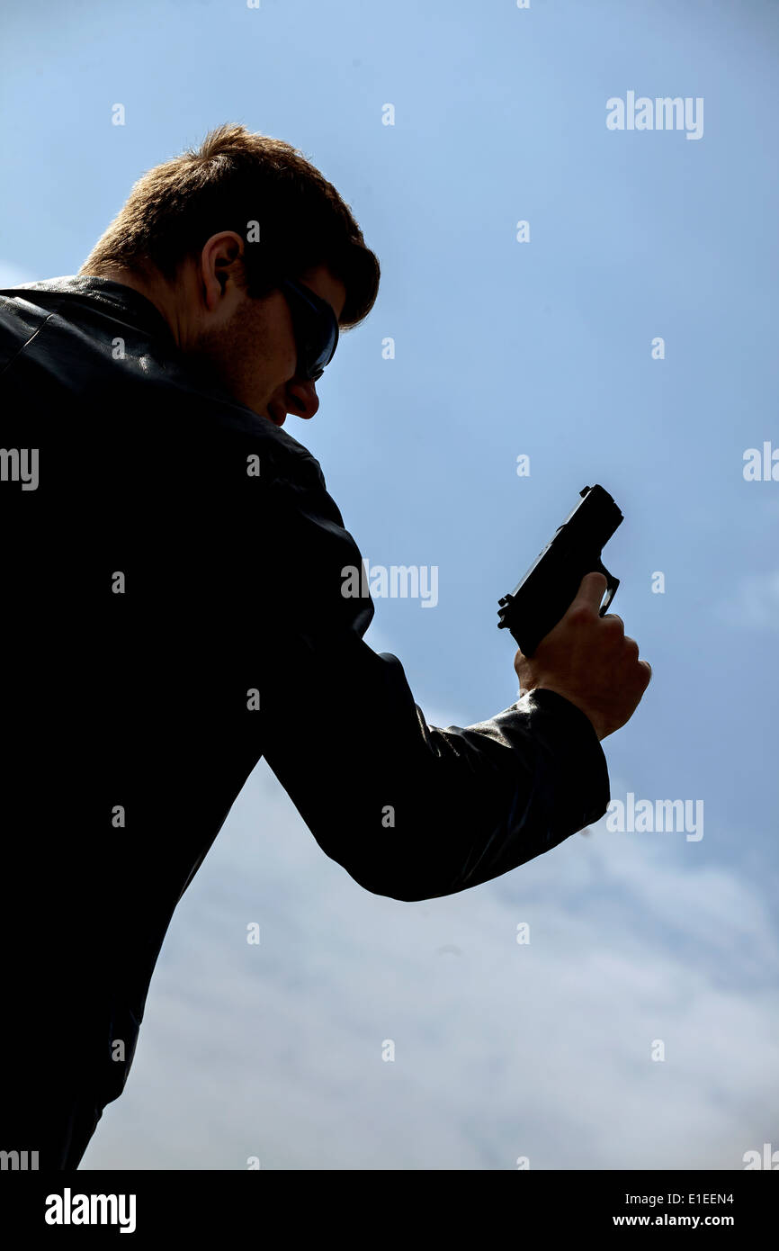 a man aiming with a gun Stock Photo
