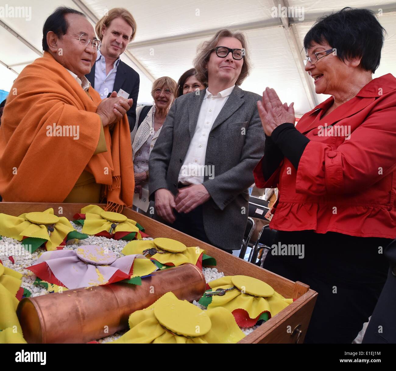 Sogyal Rinpoche (L), Tibetan meditation master and teacher of the Nyingma tradition of Tibetan Buddhism, blesses vessels next to (R-L) mayor of Bad Saarow Anke Hirschmann, architect Karl Hufnagel and chairman of the Tertoen Sogyal Foundation Heinz Siepmann during the groundbreaking ceremony for a Buddhist residential project 'Spiritual Care Center Germany' in Bad Saarow, Germany, 02 June 2014. The housing project and Spiritual Care Centre 'Sukhavati', which costs around six million euros, will receive people in need of care and sick, but also people in a life crisis, regardless of whether they Stock Photo