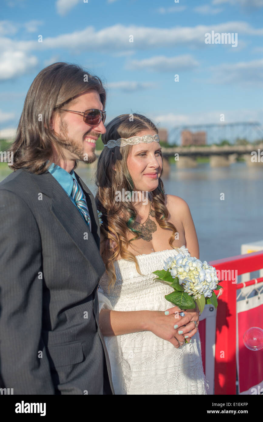 Bride and Groom with a river and bridge in the background Stock Photo