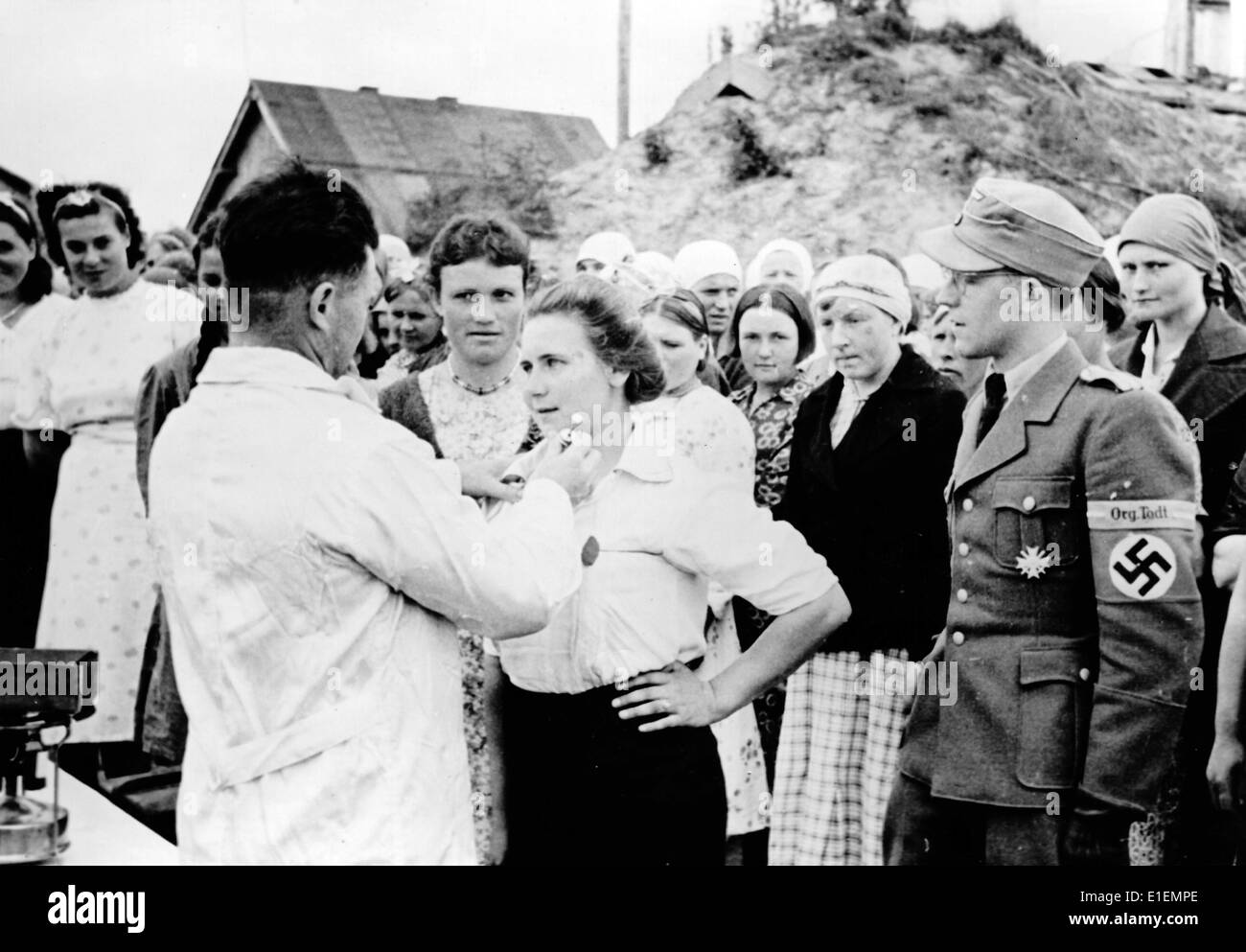 The Nazi news photo shows local woman from the areas of the Eastern Front occupied by the German army being vaccinated before their work in the Todt Organization in October 1943, location unknown. A translation of the original Nazi propaganda in German reads: Healthcare in the East. Local volunteers for service in the Todt Organization are vaccinated against disease. Fotoarchiv für Zeitgeschichte - NO WIRE SERVICE Stock Photo
