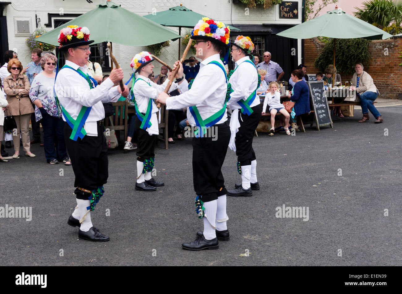 Etcetera morris men from Enfield dancing at the Fox Inn Finchingfield, Braintree, Essex, UK  as part of the Morris Ring Festival.  This festival has been held annually since 1934.  Morris dancing is an English folk dance traditionally undertaken by labourers but now by men of all classes.  The dance may be a fertility rite. 31st May 2014. Stock Photo
