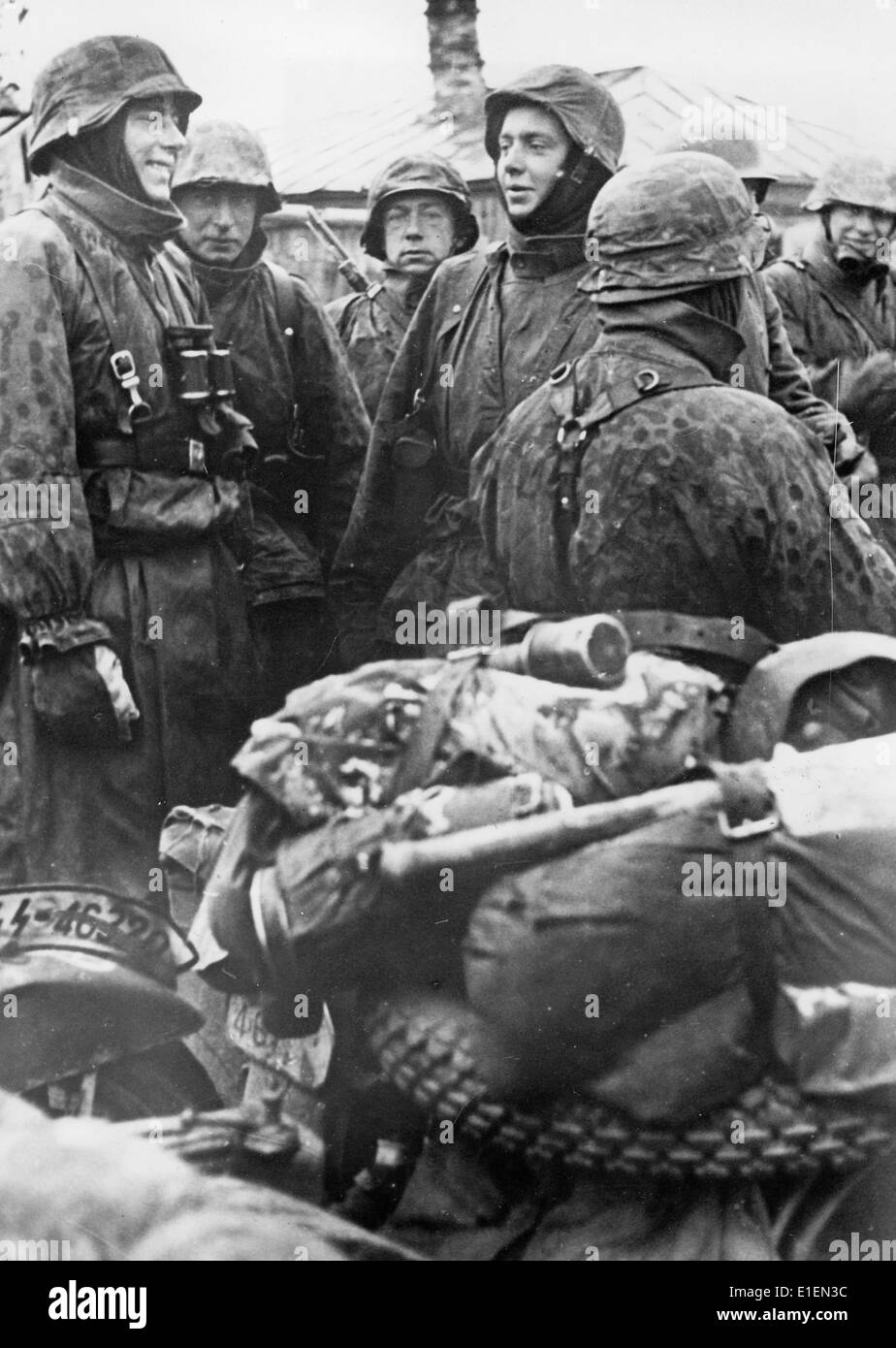Propaganda text! from Nazi news reporting on the back of the picture: 'The convoy stops! A motorcycle dispatch rider gifted witch wit and humour entertains his comrades and makes them forget the cold.' (Flaws in quality due to the historic picture copy) Fotoarchiv für Zeitgeschichtee - NO WIRE SERVICE – Stock Photo