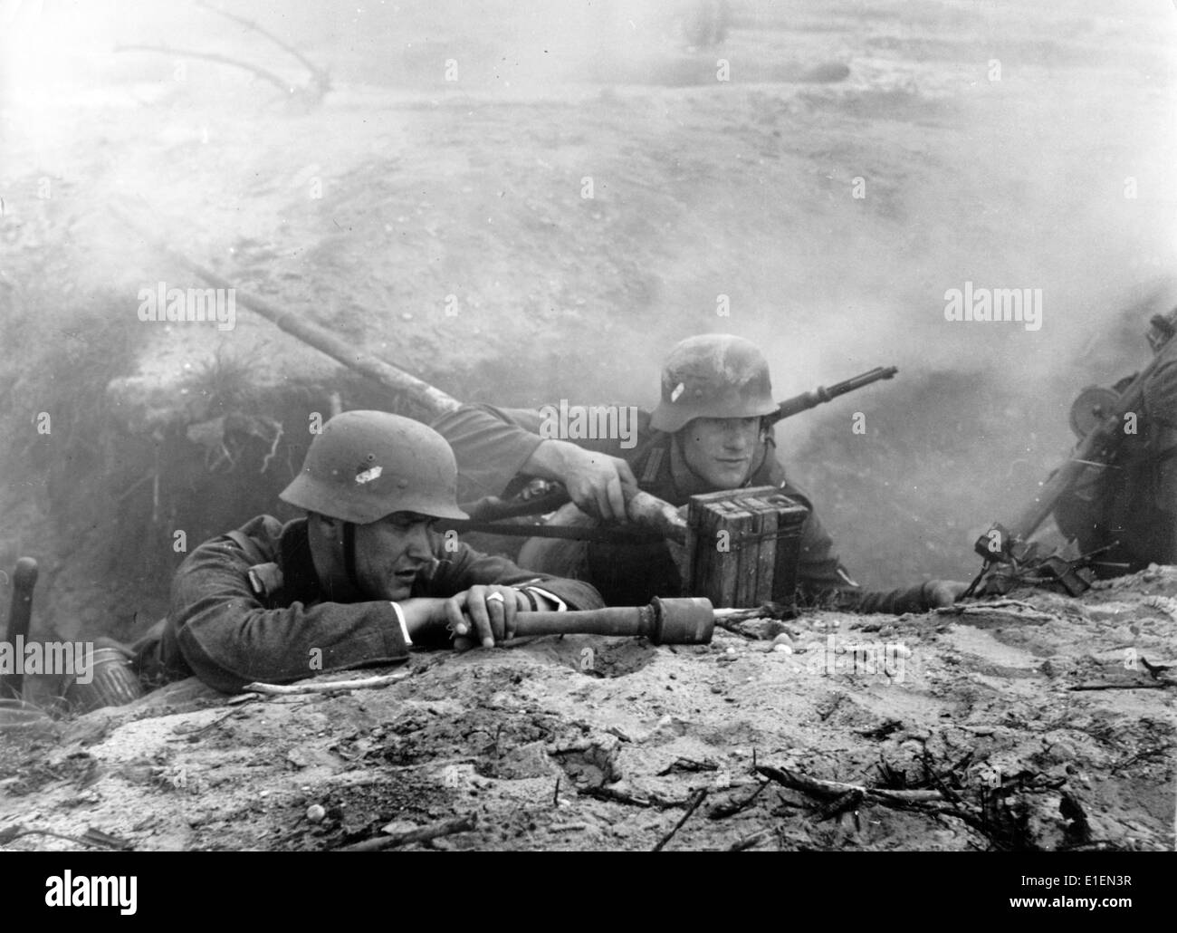 This motive from national socialist reporting shows a pioneer shock troop of the German infantry in a trench before an attack on an enemy bunker in October 1939. The leader of the assault unit fires (L) lies next to a pioneer who has an explosive charge which he is supposed to push into one of the hatches of the enemy bunker. Fotoarchiv für Zeitgeschichtee -NO WIRE SERVICE- Stock Photo