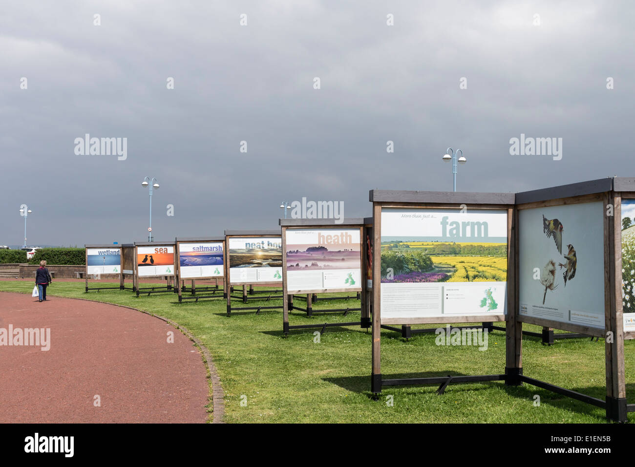 Person Walking Passing the 2020Vison Outdoor Exhibition in the Coastal Town of Morecambe Lancashire UK Stock Photo