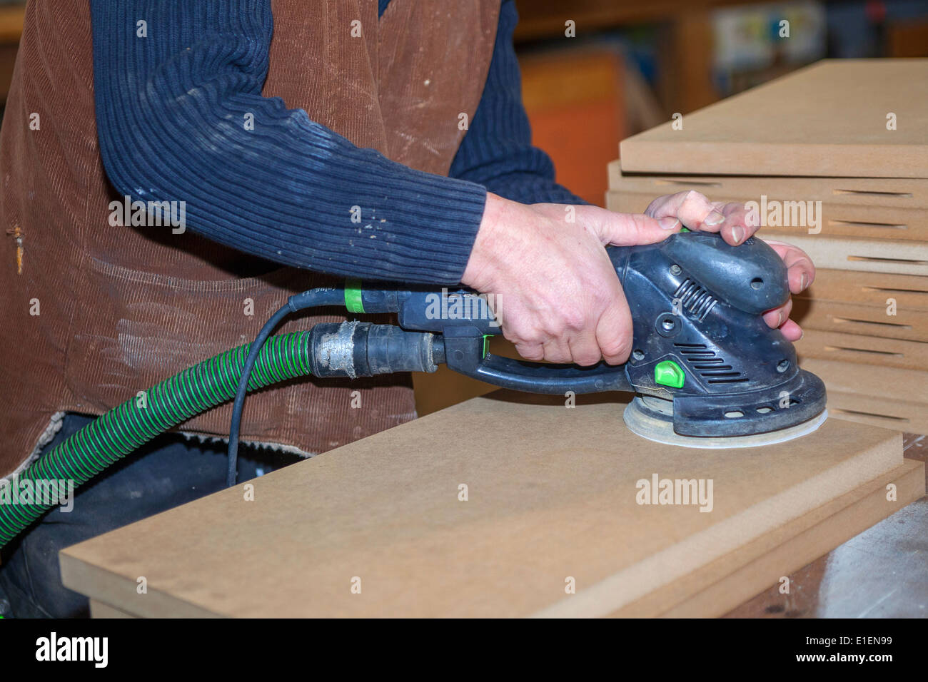 Carpenter with electric sanding machine Stock Photo Alamy