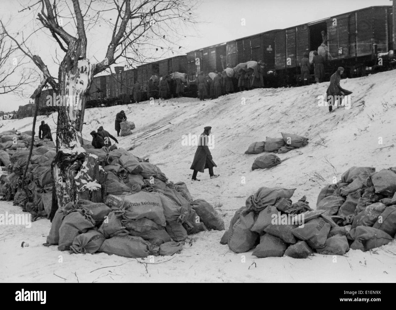 German soldiers load bags filled with post onto the trains at the Eastern Front in December 1941. The original text from the Nazi news report reads 'On the Eastern Front. The post is there! Giant heaps of mail for our soldiers arrives at the front.' Fotoarchiv für Zeitgeschichtee - NO WIRE SERVICE Stock Photo