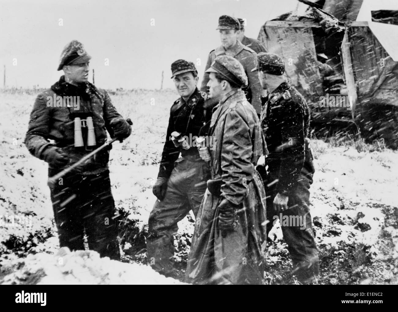 German soldiers prepare to attack American troops along the Huertgen Forest front near Aachen, Germany, December 1944. The Nazi propaganda text written on the back in 22 December 1944 reads: 'On the southern wing of the Aachen Front. Before the attack by German tanks, there is a short discussion. The dense snow makes it easy to carry out the plans, making it possible for German tanks to approach the opponents without being noticed.' Fotoarchiv für Zeitgeschichtee - NO WIRE SERVICE Stock Photo