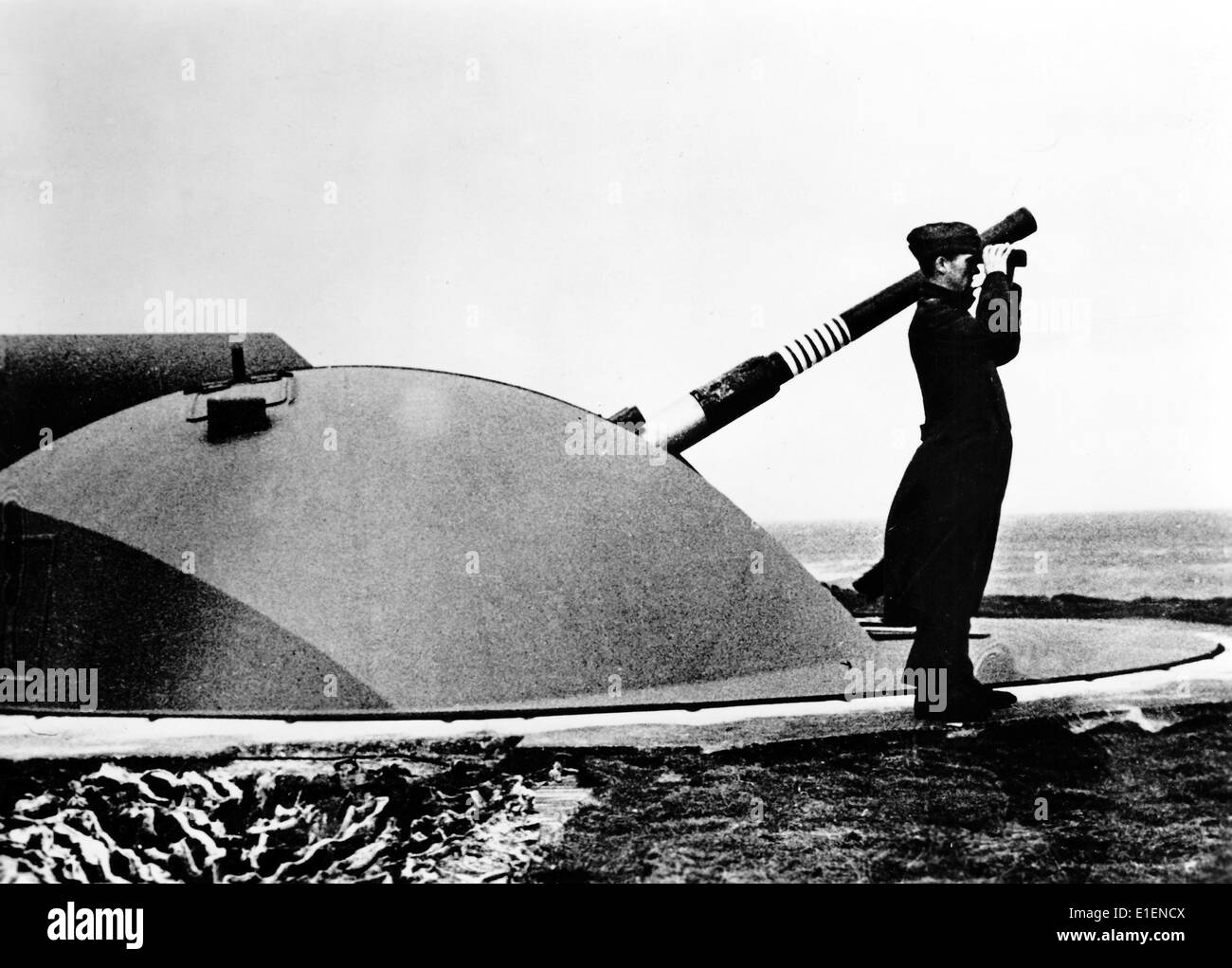The picture from a Nazi news report shows a soldier from the German army looking through binoculars at a fortification along the Atlantic Wall in April 1943. The original text on the back of the picture reads 'The rings on the barrel show that the enemy has tried to attack the vast fortifications repeatedly.' Fotoarchiv für Zeitgeschichtee - NO WIRE SERVICE Stock Photo