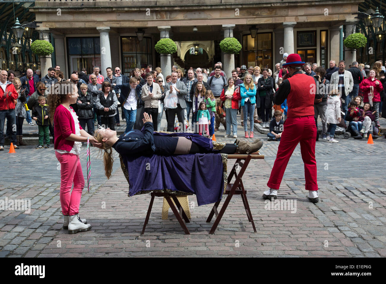 Street performer in Covent Garden delighting the gathered crowds with