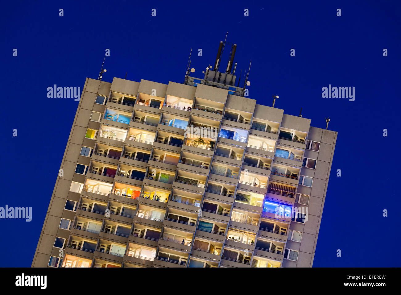 A tall illuminated apartment building at Europaplatz in Aachen, Germany