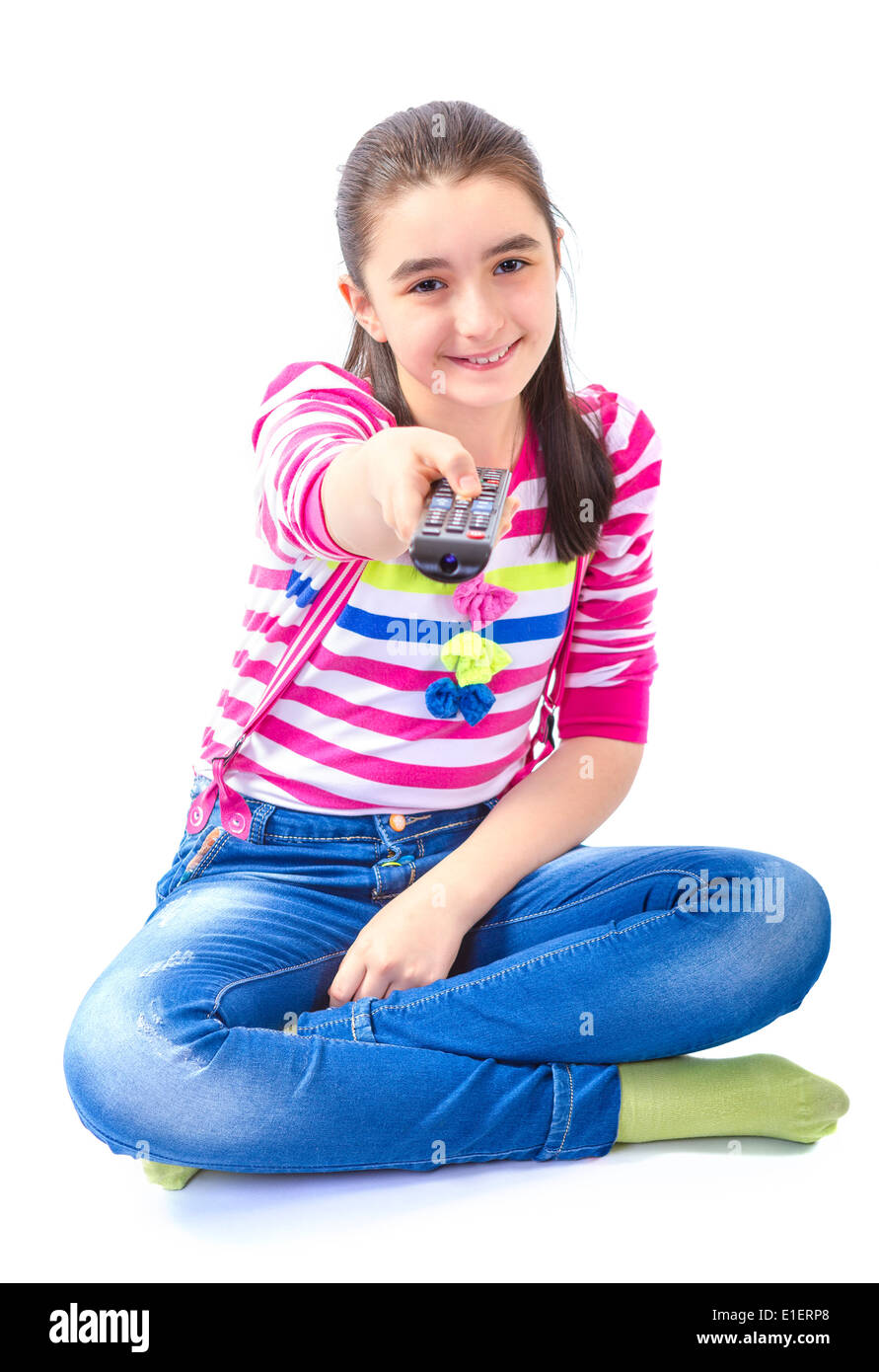 Little girl with remote control sitting down and watching tv Stock Photo